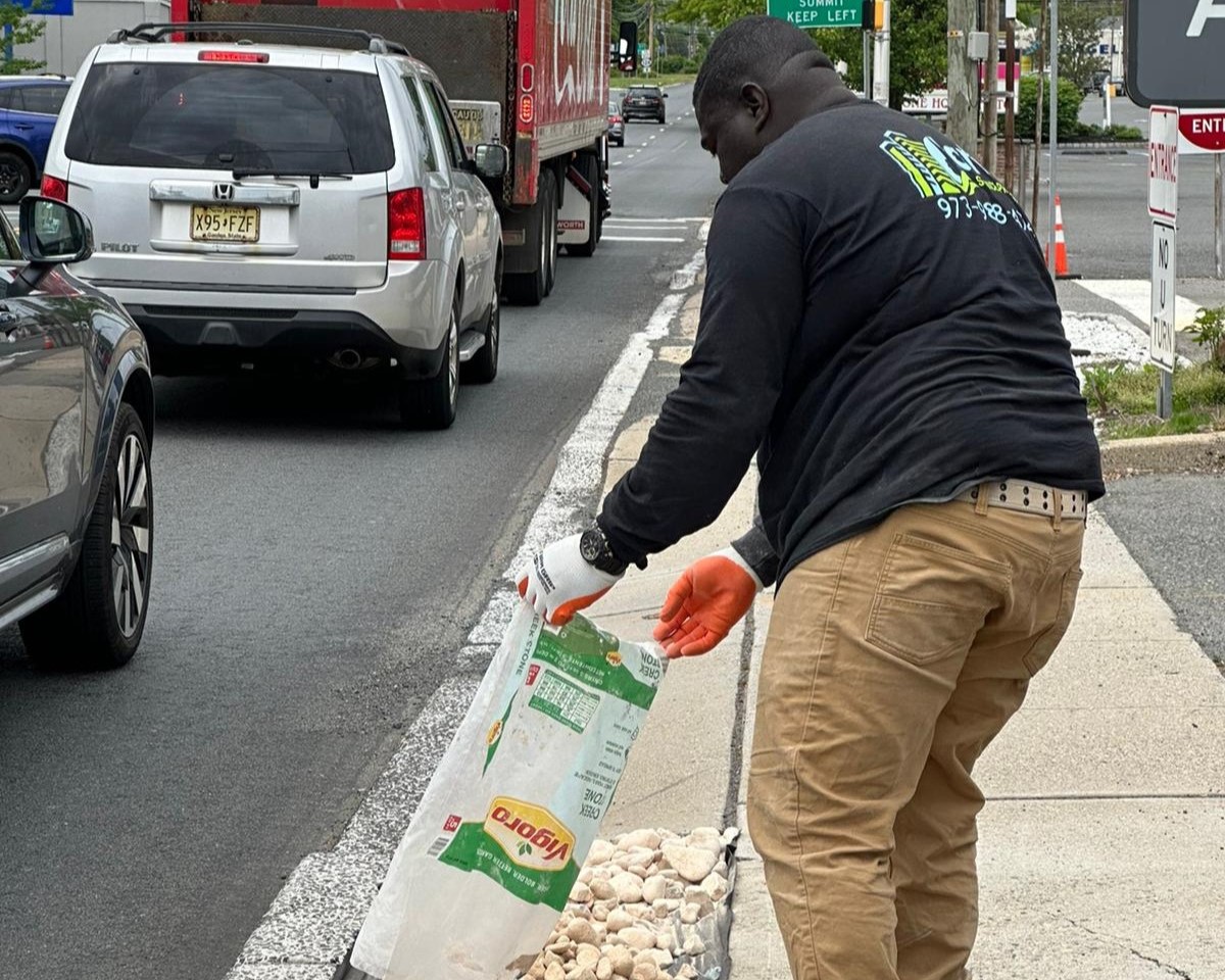 The Clarkes professional employed filling the curb with a bag of rock
