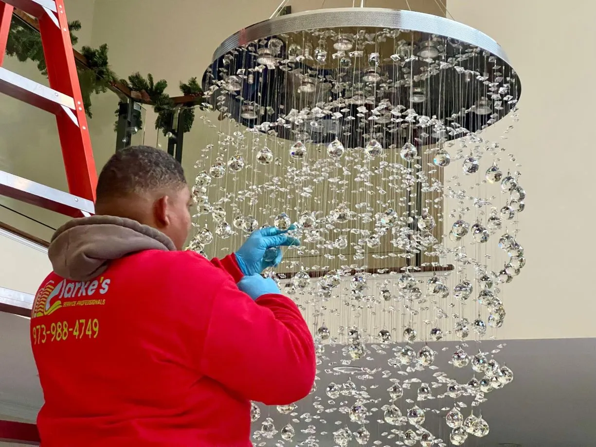 A Man Providing Chandelier Cleaning Service