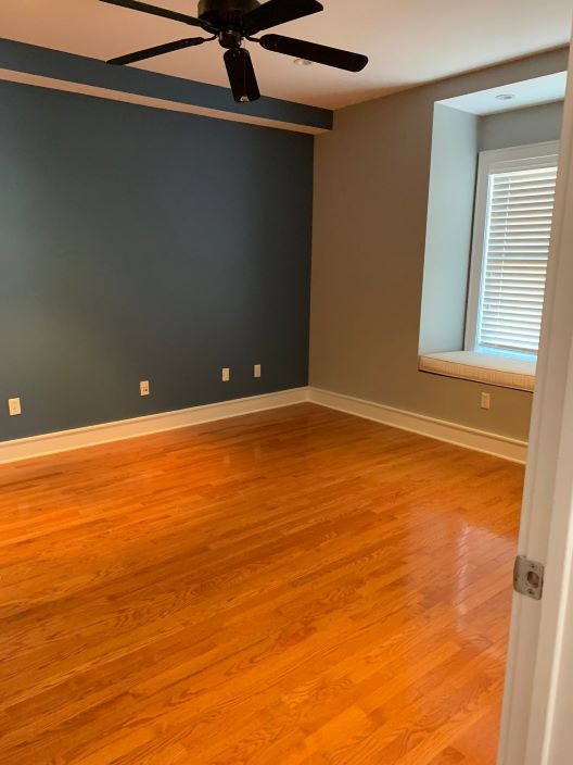 A room with a wood floor repaired by Clarke's professional.