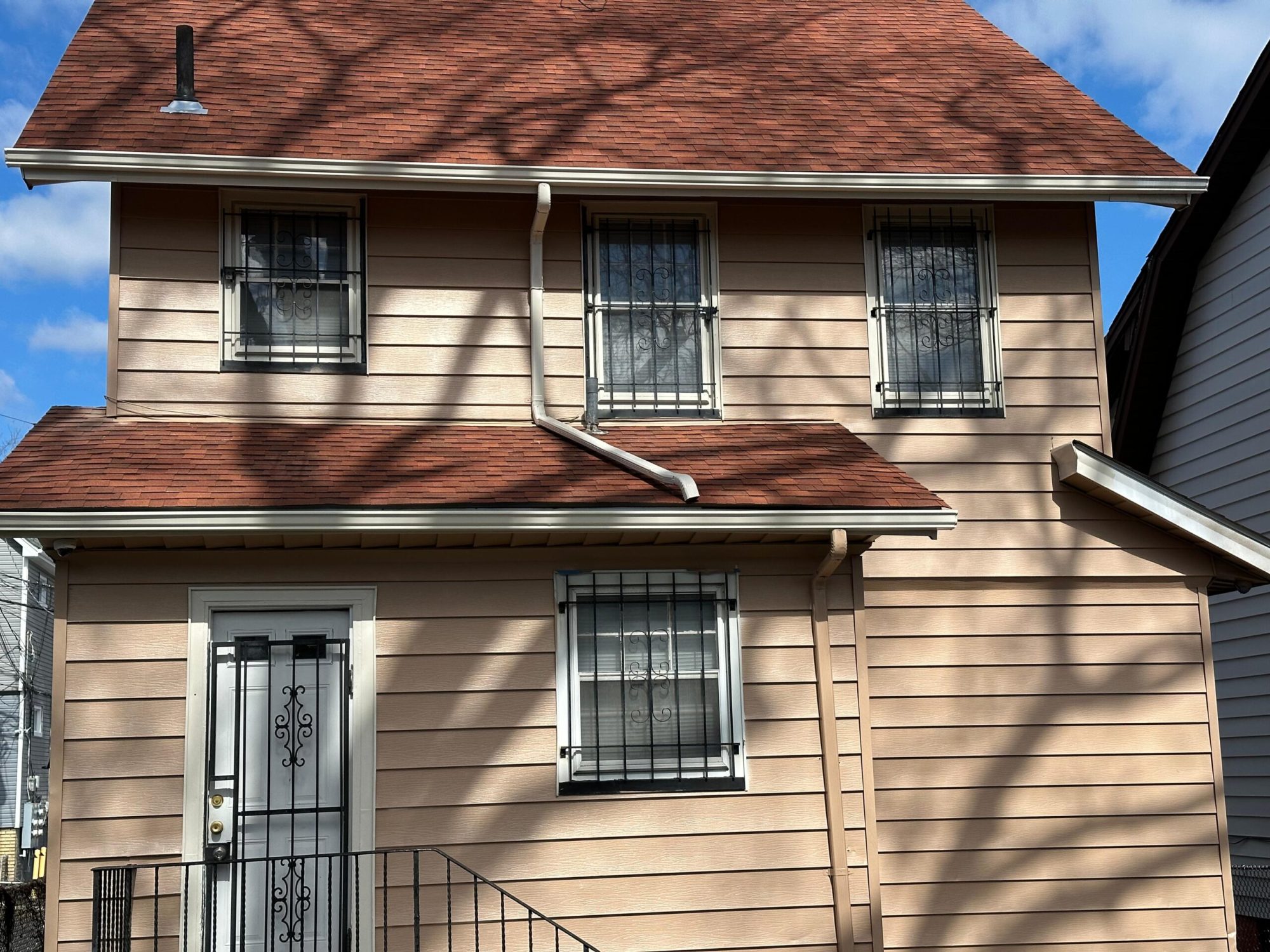 A house with a gutter on the roof cleaning service done by Clarke's professional.